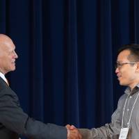 James Nguyen shaking hands with Dr. Potteiger.
